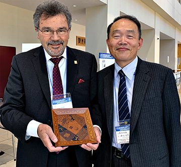 Denoble receives keynote speaker recognition with Dr. Shinya Suzuki.