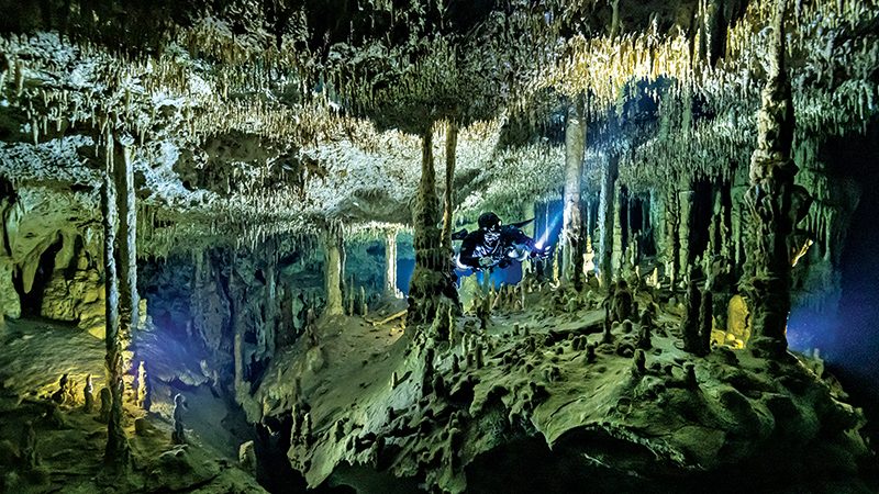 A diver explores Dreamgate Cenote in Mexico