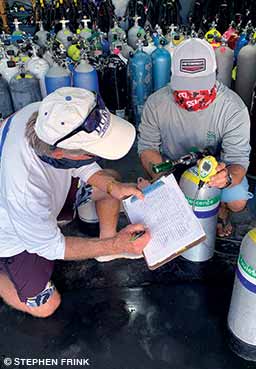 dive operators inspecting cylinders