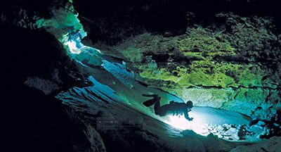 cave divers using lights