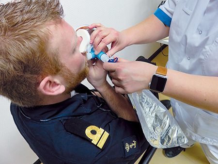 Researchers sample exhaled air in a special bag before transferring it to a Tenax sorbent tube.