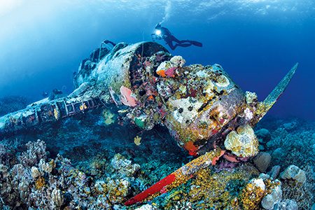 A diver explores the World War II Japanese Jake seaplane in Palau.