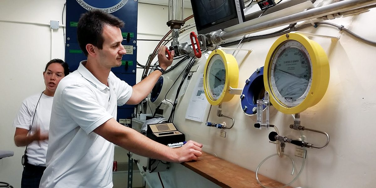 Garbino monitors physicians in dive training in a hyperbaric chamber