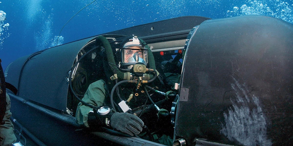 A U.S. Navy SEAL prepares to emerge from a SEAL Delivery Vehicle (SDV)