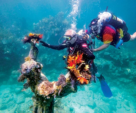 Murray guides Gabe Spataro, who is visually impaired, to the Christ of the Abyss statue