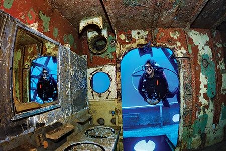 Diver explores shipwreck.