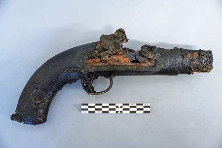 A Royal Navy pistol was recovered from a seamen’s chest in the forecastle on the lower deck of HMS Erebus.