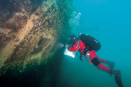 Parks Canada UAT diver Jonathan Moore observes the stern gallery of HMS Terror. 
