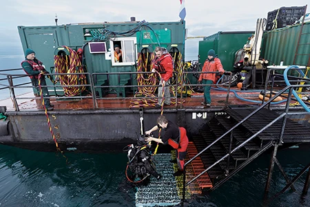 Dive operations are in progress aboard the barge.