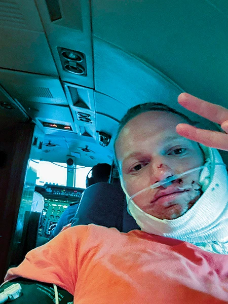 An injured Robert Porter poses for a selfie and throws up a peace sign.