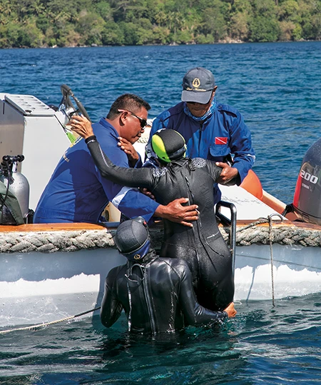 Assisting diver out of water.