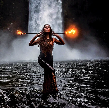 She fire dances at Abiqua Falls, Oregon.