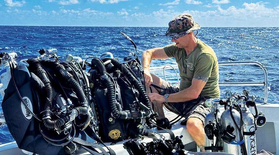 Rob DeProy, retired Royal Canadian Navy coxswain, prepares his equipment for a dive