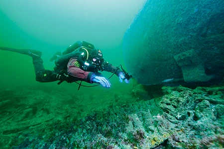 Diver inspecting wreck.