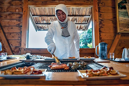 Hayashi wears the ama’s traditional outfit as she prepares squid