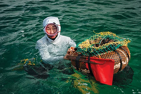 Hayashi treads water next to a floating net.