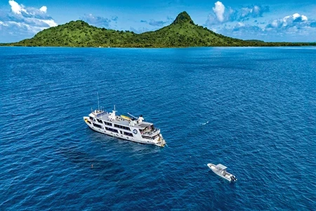 An aerial view shows a liveaboard dive boat moored next to the World War II shipwreck Yamagiri Maru off Dublon Island