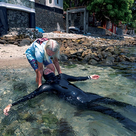 She dragged the diver to the beach.